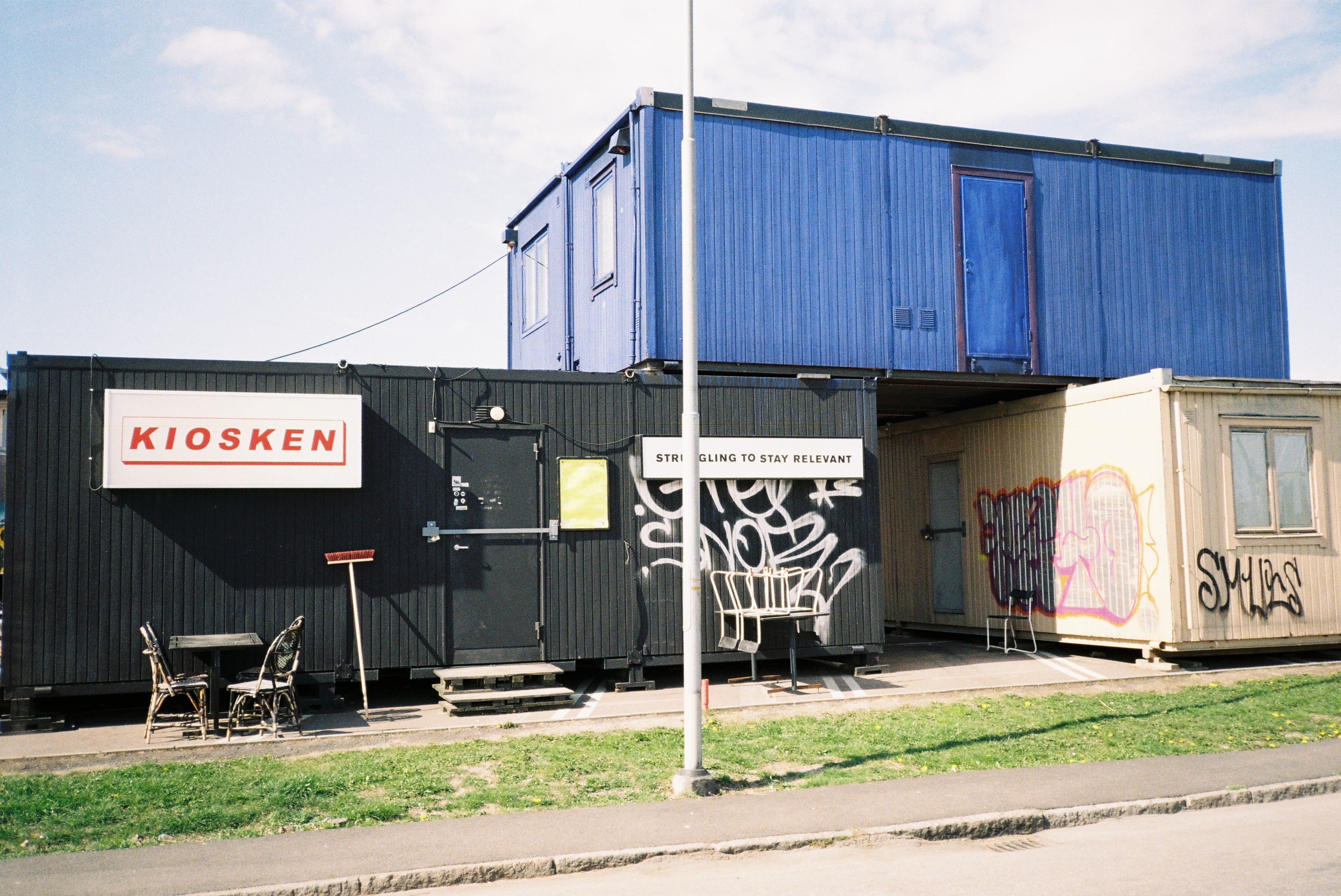 Kiosken at Ringön: a black shipping container with the Kiosken sign and a 'Struggling to stay relevant' notice on the door — the cultural hub run by participants in the research.