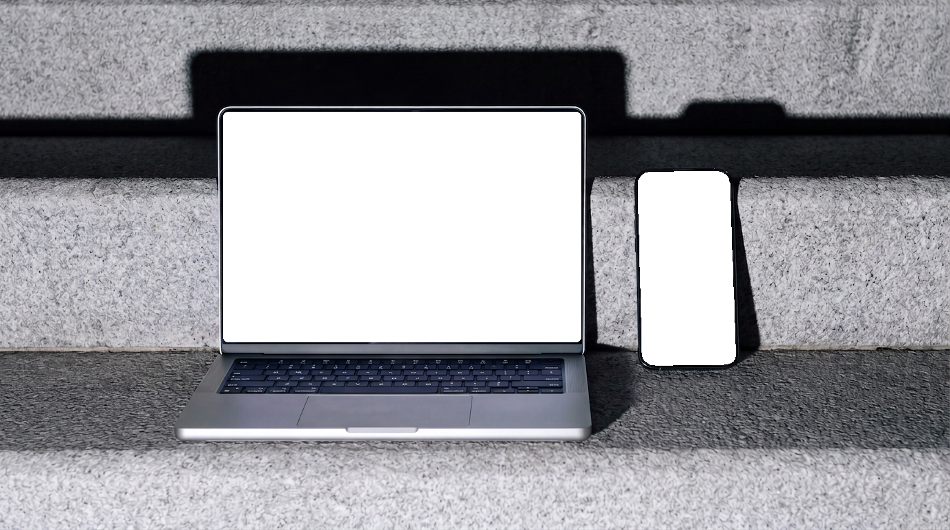The portfolio site shown on a MacBook and an iPhone resting on concrete steps